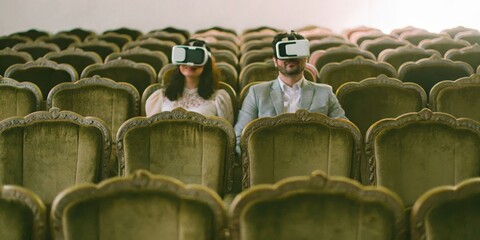 Couple experiencing virtual reality in an elegant theater setting