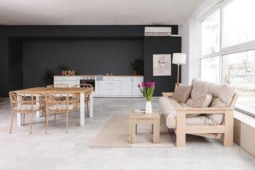 Studio apartment with comfortable sofa and dining table