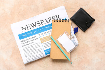 Composition with newspaper, notebook, wallet and badge on color background