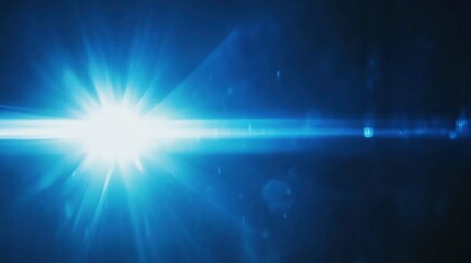 Obraz premium Bright blue light with lens flare, and beams shining in a dark background.