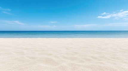 Obraz premium Serene beach scene under a vibrant blue sky. Soft, warm sand meets the calm, turquoise ocean