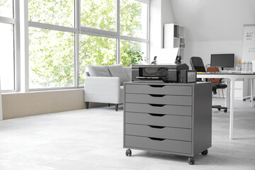Modern printer on chest of drawers in stylish office