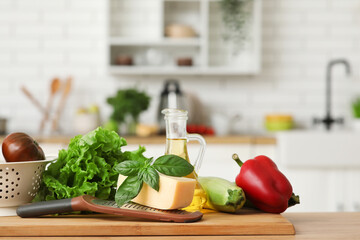Grater, ingredients and cutting board on table in kitchen