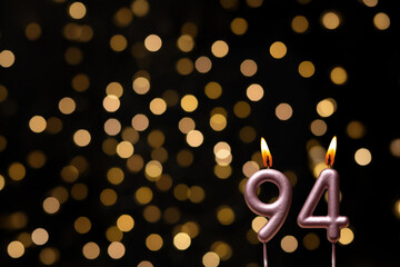 Birthday candles with number and blurred background lights