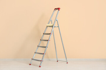 Maintenance ladder near beige wall