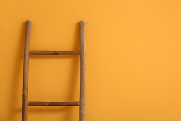 Wooden ladder near yellow wall in stylish room