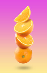 Fresh juicy oranges falling on color gradient background