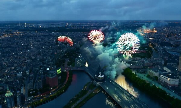 View of fireworks and fireworks from a bird's-eye view over the city of Minsk. Colored lights in the sky over a river in Europe. Celebratory salute. Victory day may 9