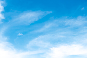 Light clouds on bright blue sky summer background