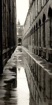 Fototapeta Grayscale City Alleyway Reflection in Puddles
