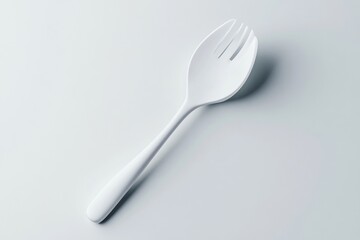 White plastic utensil, spoon-fork hybrid
