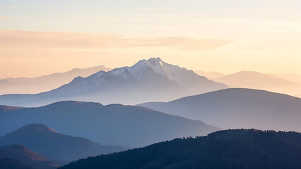 Mountain range at dawn with layered mountains and soft light.