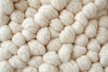 Close-up of creamy white wool rug with braided texture and soft fluffy surface for home decor