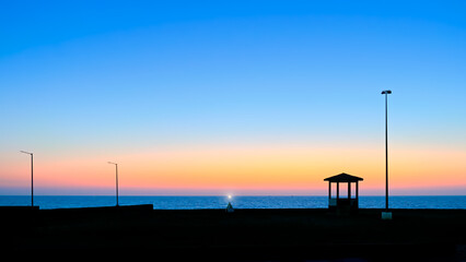 Beautiful sunset and Bhadkeshwar Mahadev temple on the sea shore of Dwarka, Gujrat, India