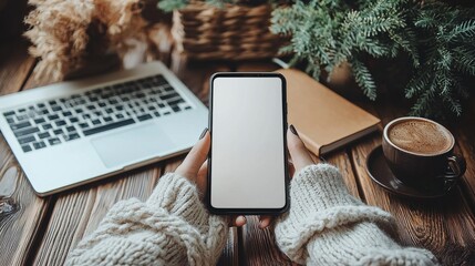 Cozy winter scene of a comfortable workspace with a laptop mug of hot beverage and a small fir tree creating a serene and relaxing atmosphere for remote or freelance work