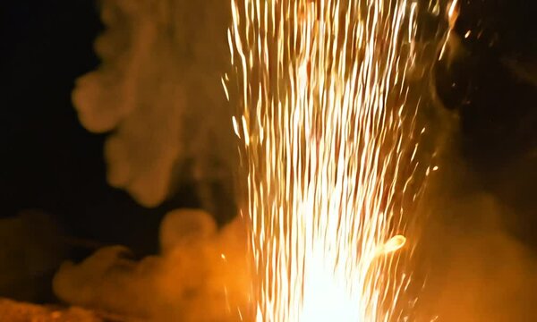 bright sparkling sparks and smoke from the fire