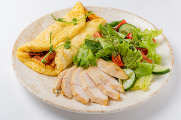 omelet with vegetables on the white plate