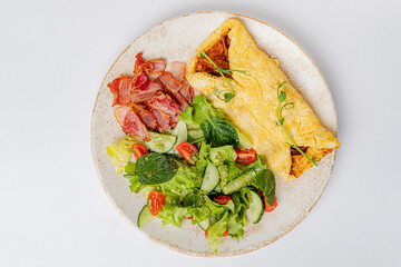 omelet with vegetables on the white plate