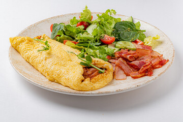 omelet with vegetables on the white plate