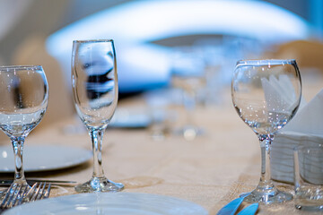 Empty wine glass and cutlery on a table in a restaurant