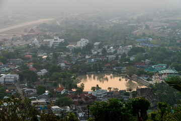 Aerial view of Mae Hong Son town with lake and rolling mountains in the background, Thailand