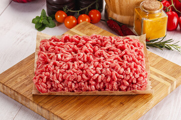 Raw minced beef meat over board