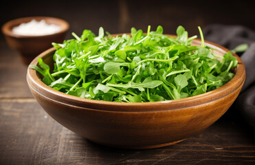 Simple arugula salad in rustic wooden bowl
