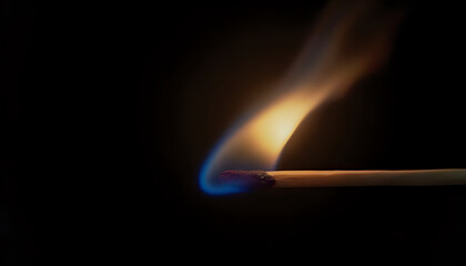 a match burning with blue flames on a black background