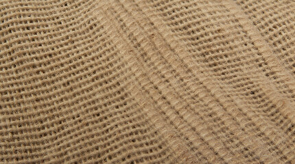 Close-up view of a rough burlap texture, showcasing the coarse weave and earthy brown tones