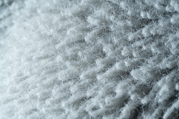 A close up of a fuzzy, white, and gray surface