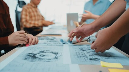 Dynamic teamwork scenario showcasing hands analyzing project blueprints in a modern office. Highlights collaboration, creativity, and innovation in a professional setting. SACTR