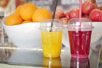 Freshly made fruit juices displayed at a vibrant market stall