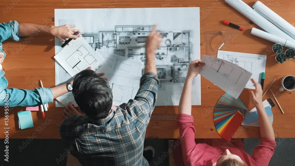 Poster group of people looking at blueprint while brainstorming idea. top view of engineer team looking and