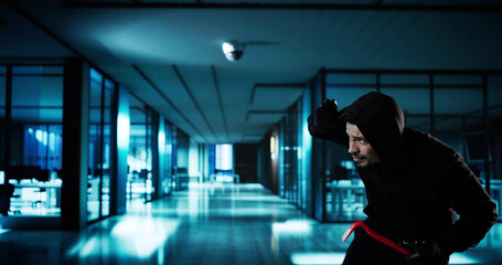 Man In Hooded Sweatshirt Trying To Hide