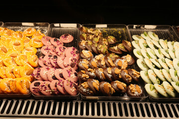 Colorful assortment of traditional sweets displayed in a market stall