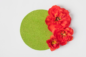 Spring composition on gray background of flowers red tulips with with a green circle made of paper for text. Happy Mother's Day greeting card, happy Valentine's Day, March 8, happy birthday