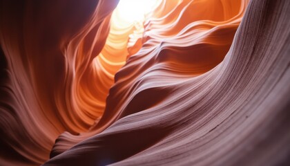 Wavy sandstone canyon walls with dramatic lighting create an abstract and mesmerizing natural landscape for backgrounds or textures.