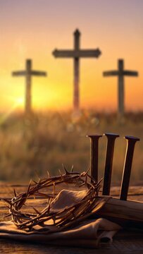 Crown of thorns and nails with three crosses at sunset