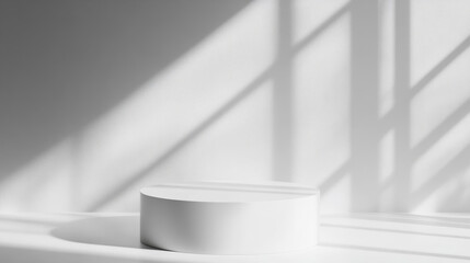 Minimalist white pedestal casting shadows in bright space creates serene atmosphere