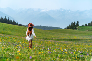 Young woman traveler relaxing and enjoying beautiful Scenery landscape with colorful flowers in...
