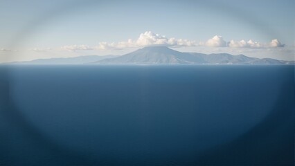 Fototapeta premium Bay of Naples Vista in Italy Naples showcases stunning landscape with calm blue water, distant mountain peak. Concept of tranquility featured in Bay of Naples Vista in Italy Naples.
