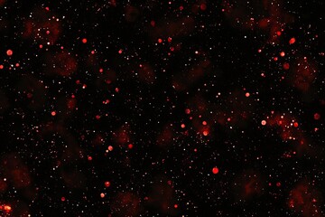 Red glitter sparkles on black background for festive designs and magical atmosphere creation