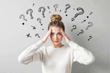 Confused woman with hands on head surrounded by question marks, realistic style, on gray background, concept of decision making and mental overload. Ai generative