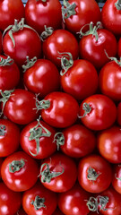 background of small red tomatoes with green tails