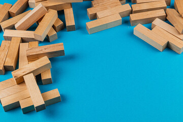 Wooden blocks scattered on blue surface for play