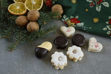 Christmas cookies with walnuts, pine branches and a  festive Christmas tablecloth.