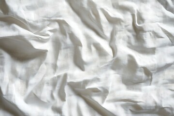 Obraz premium Crumpled white fabric texture background with soft folds and shadows for graphic design use