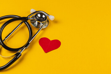 Stethoscope and heart shape on vibrant background