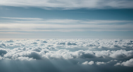 Fototapeta premium A mesmerizing aerial view captures a sea of fluffy white clouds beneath a blue sky.