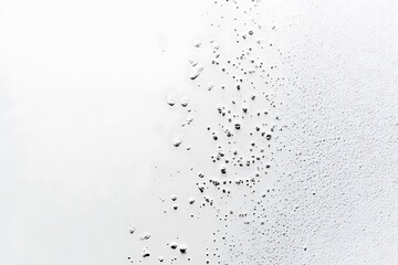 Obraz premium Water droplets on a glass surface create an abstract pattern, ideal for backgrounds and textures
